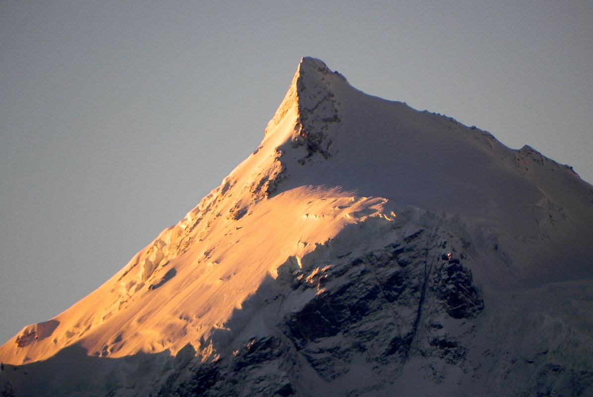 08 Phola Gangchen Close Up At Sunrise From Shishapangma North Base Camp Phola Gangchen (7661m) glows at sunrise from Shishapangma North Base Camp (5029m). Phola Gangchen (Molamenqing) was first climbed by Bruce Farmer and Dick Price of New Zealand on May 14, 1981. They were followed by Warwick Anderson and Ron McLeod on May 16 and Geoff Gables, Bruce Clark, Paul Chapman and Tony Charlton on May 20.